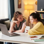 Two Students Working Together On Project